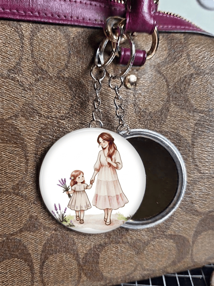 mirror keyring with illustration of a woman and a child on a brown textured surface