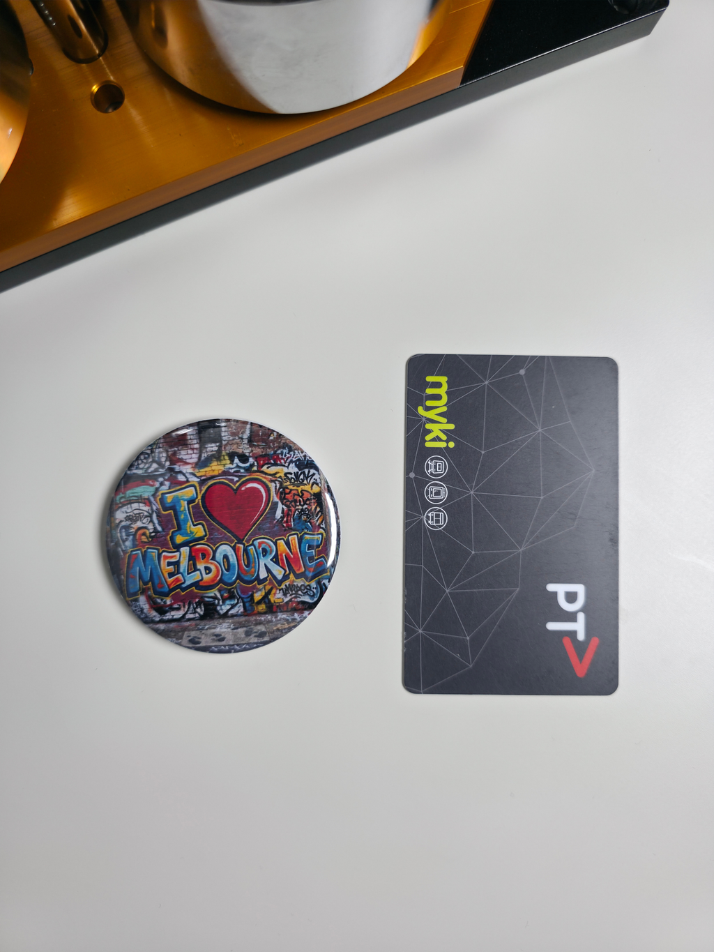 Round 'I ❤️ Melbourne' magnet and rectangular card on a white surface