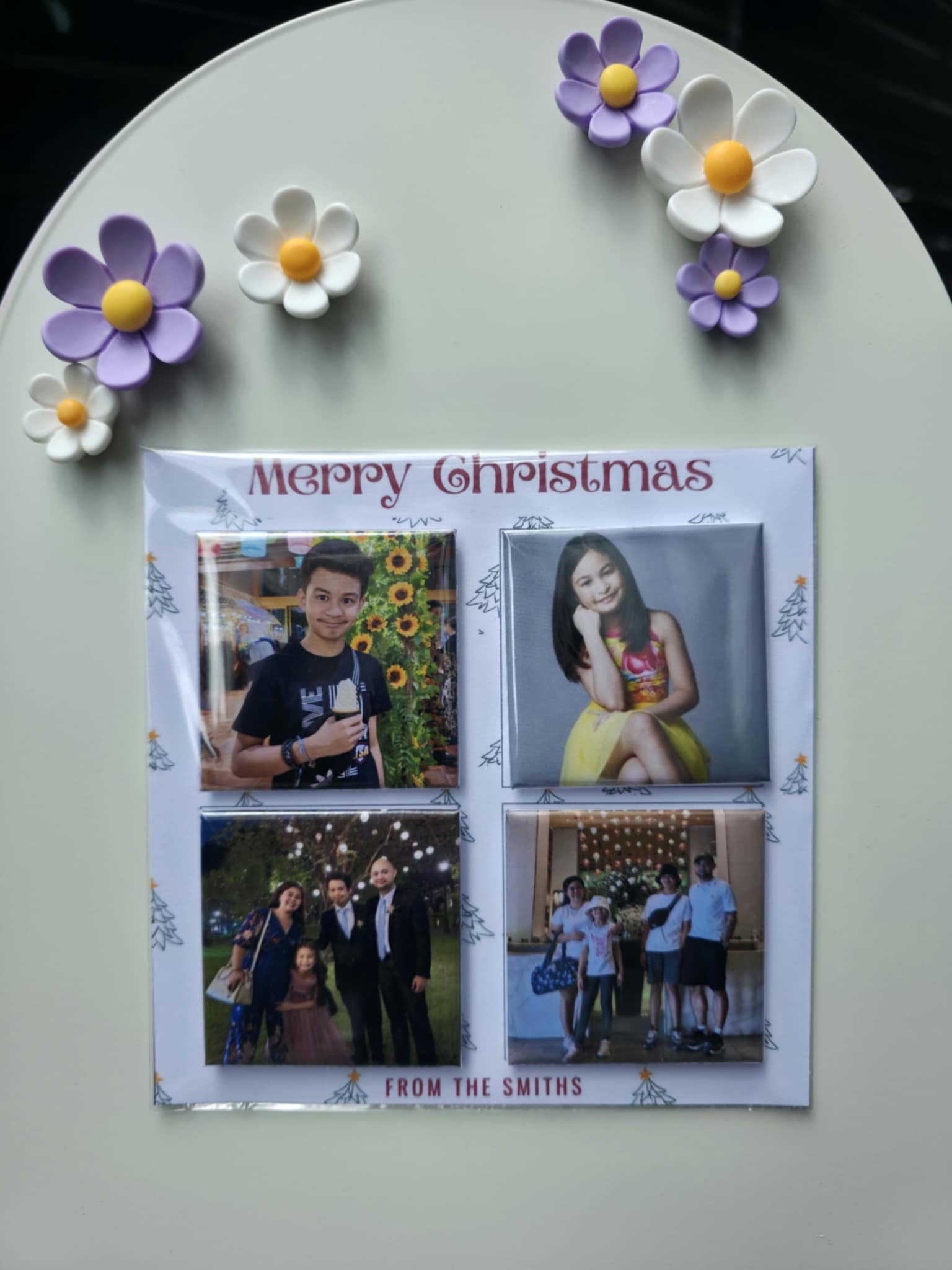 Decorative photo collage with flowers and 'Merry Christmas' text on a white surface.