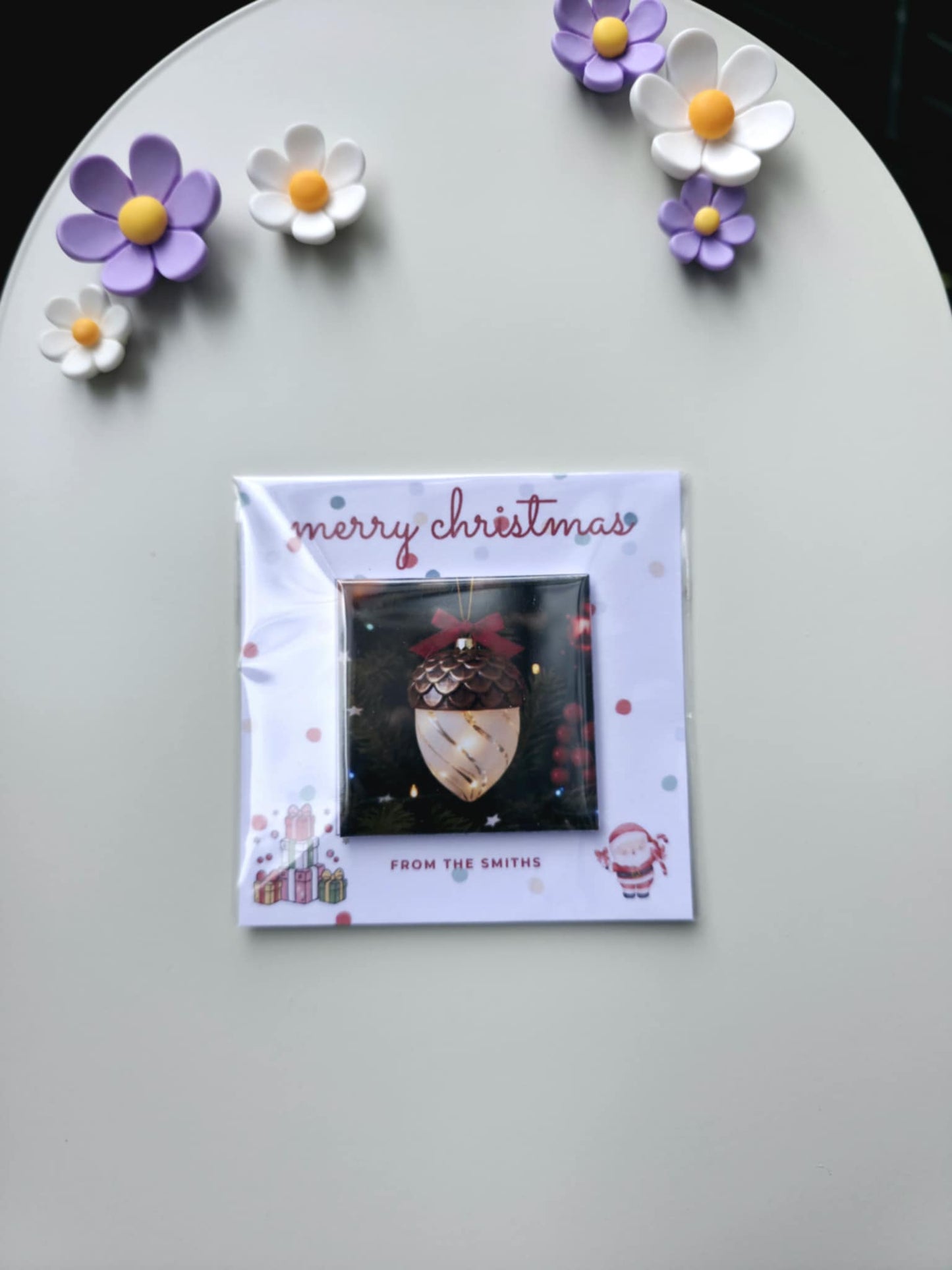 Christmas card with decorative flowers on a gray surface