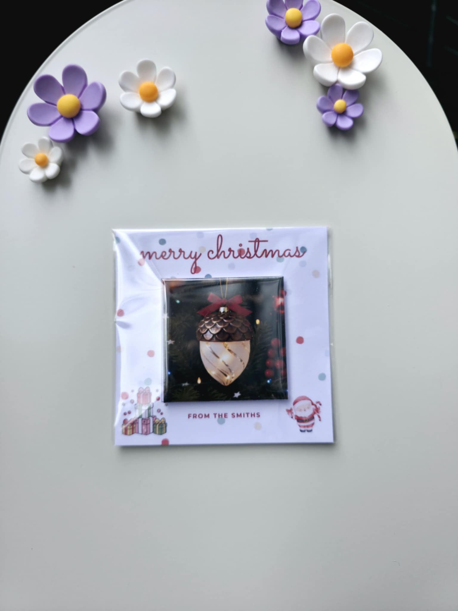 Christmas card with decorative flowers on a gray surface