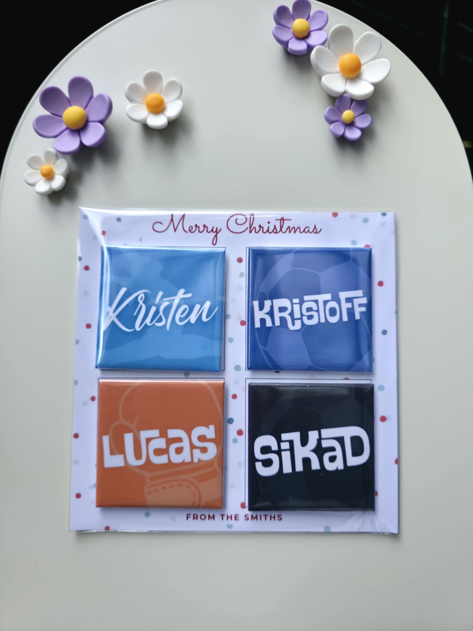 Set of personalized name cards with decorative flowers on a white surface