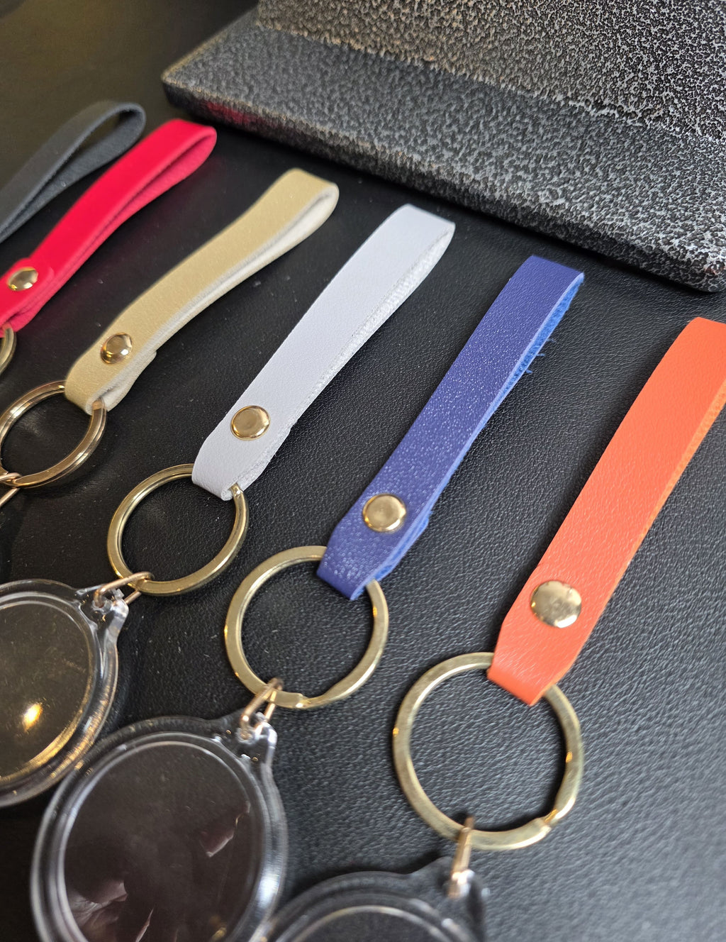 Set of keychains with colorful straps on a dark surface