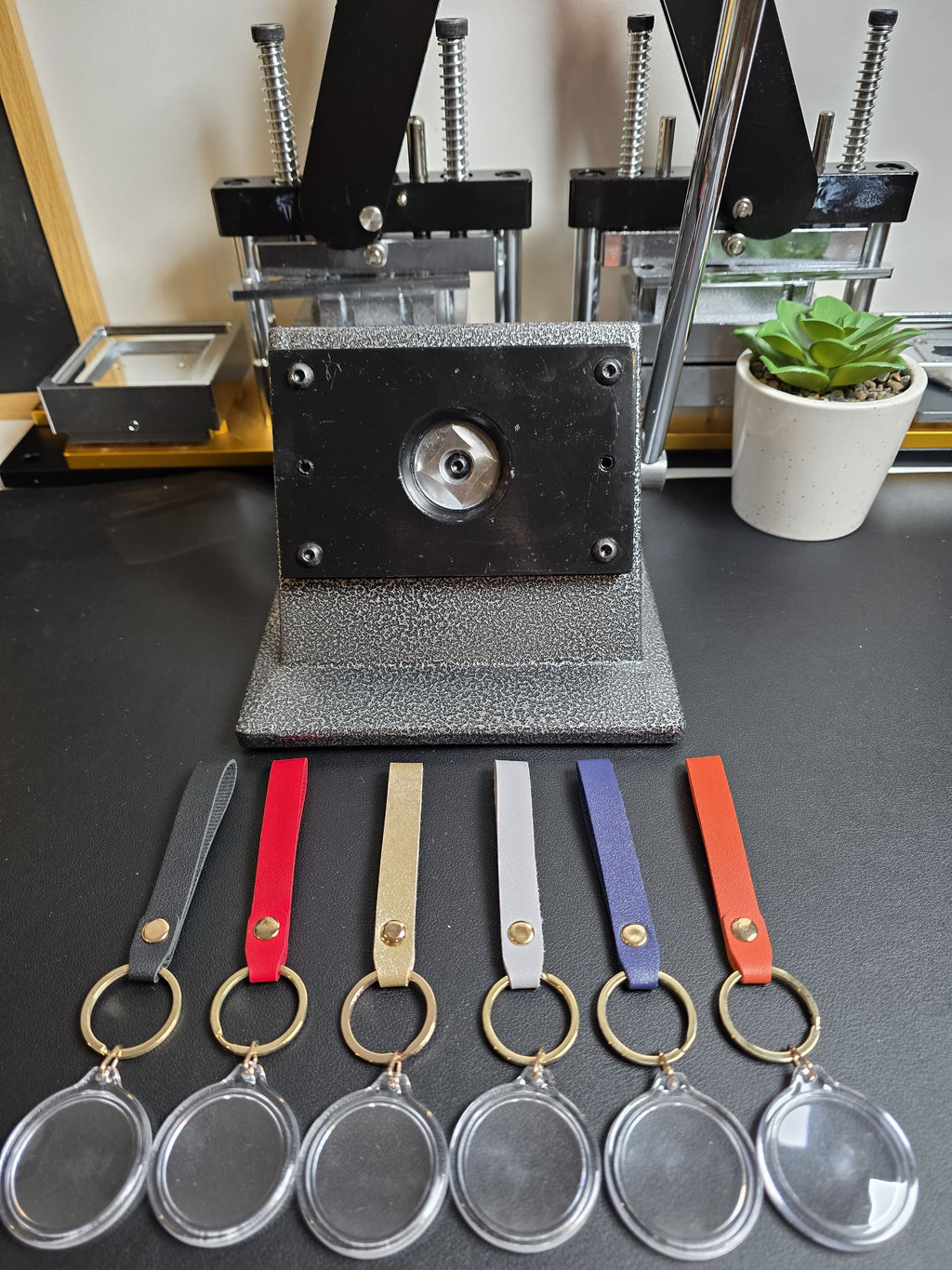Keychain making machine with keychains on a table