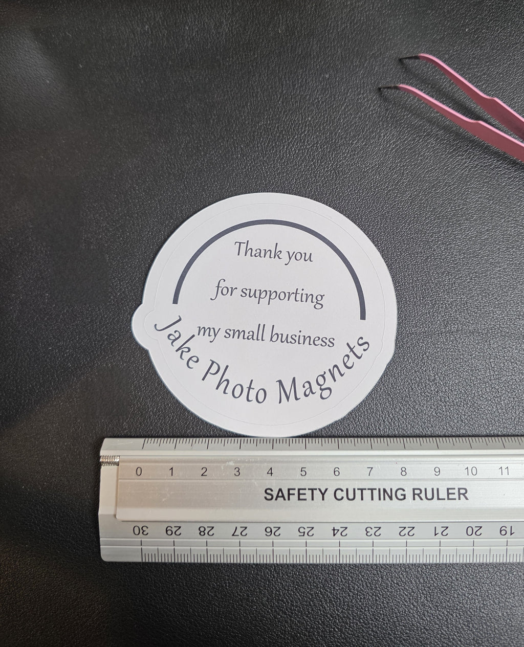 circle custom thank you packaging stickers with a ruler for scale