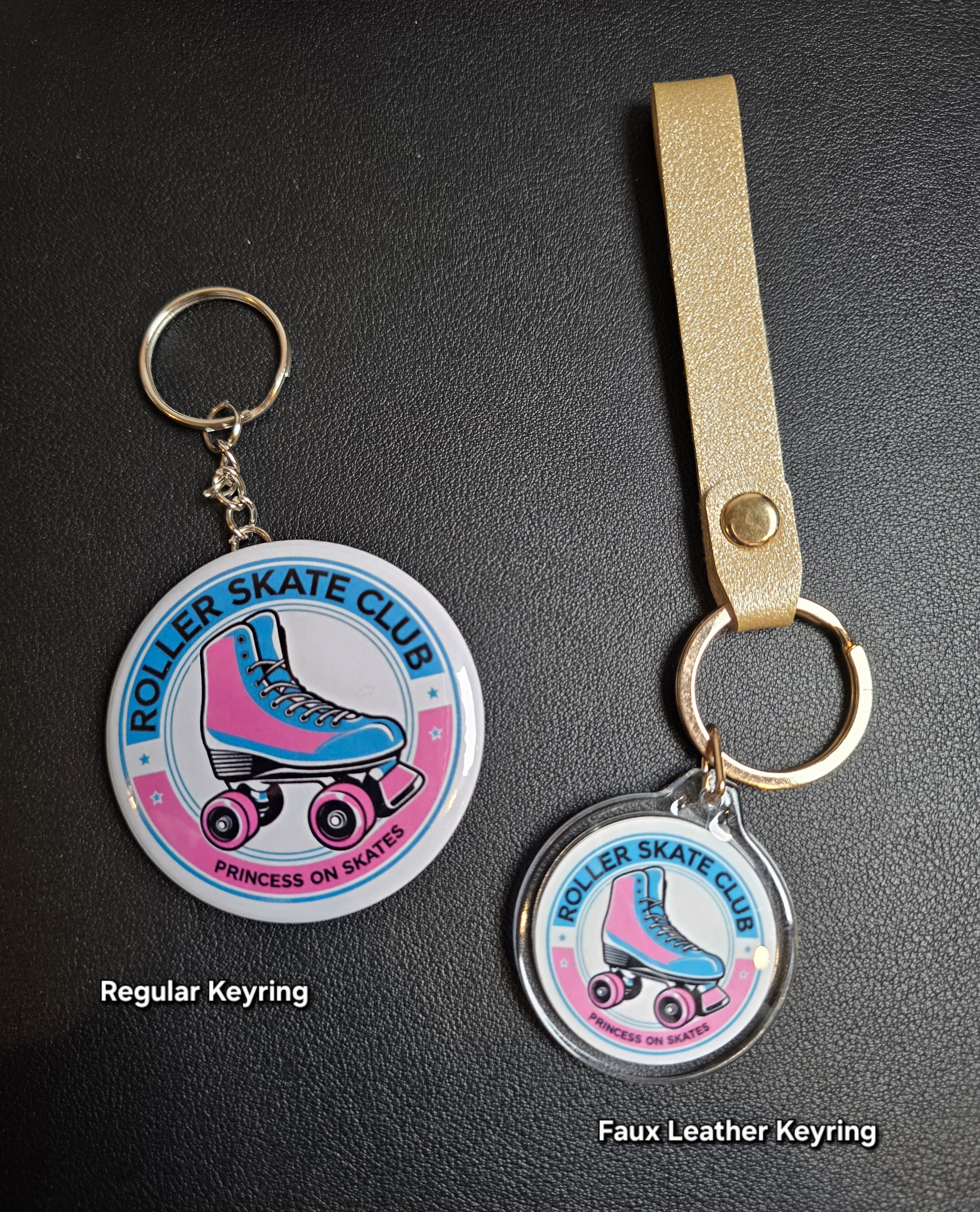 Two keyrings with roller skate design on a black background
