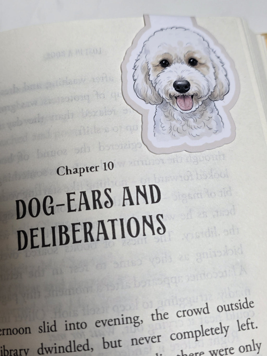 Book with a dog-shaped bookmark on a page titled 'Dog-Ears and Deliberations'.