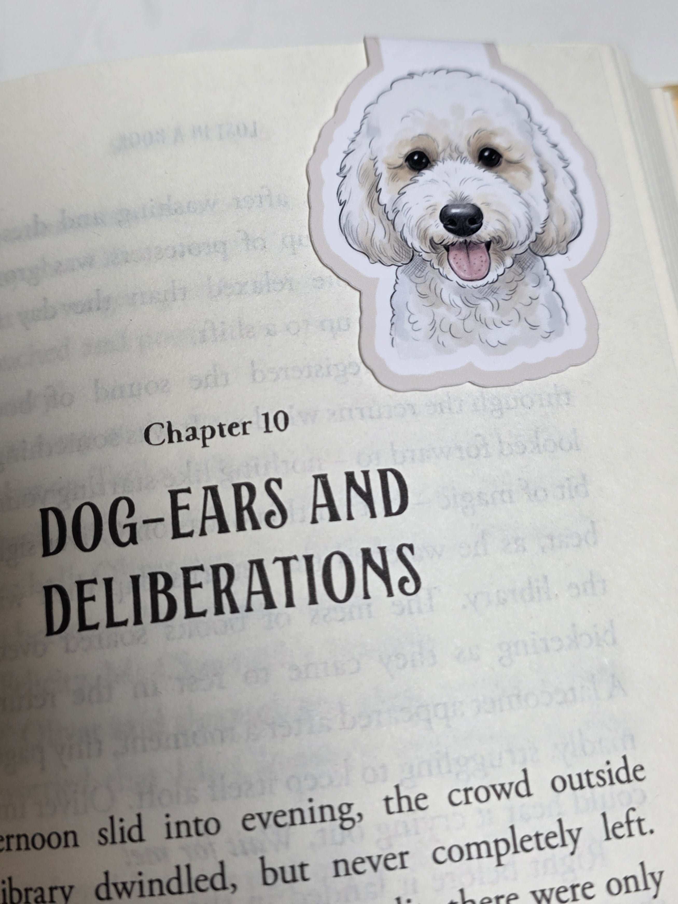 Book with a dog-shaped bookmark on a page titled 'Dog-Ears and Deliberations'.