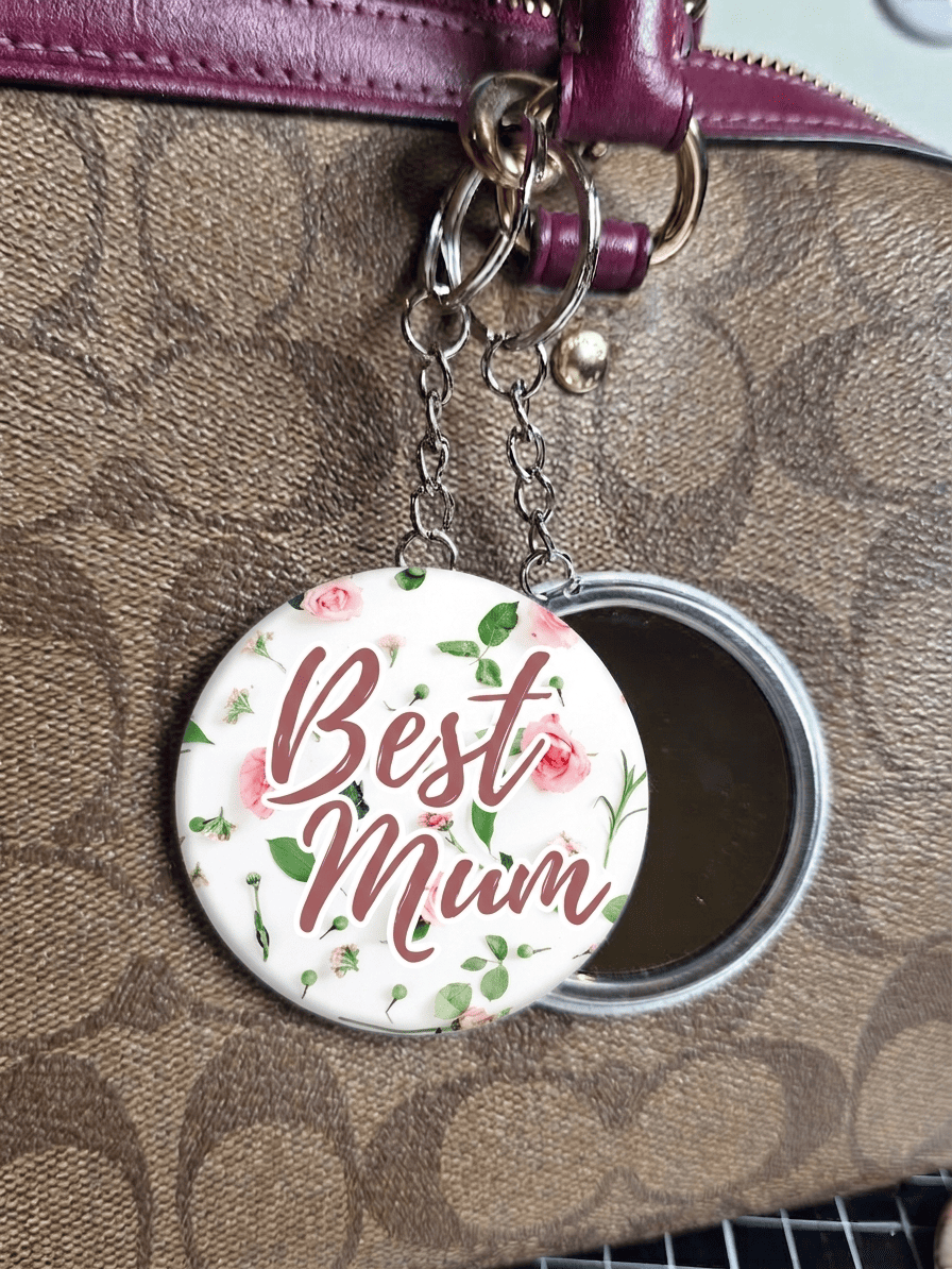 mirror key ring with 'Best Mum' text on a floral design against a brown textured background.