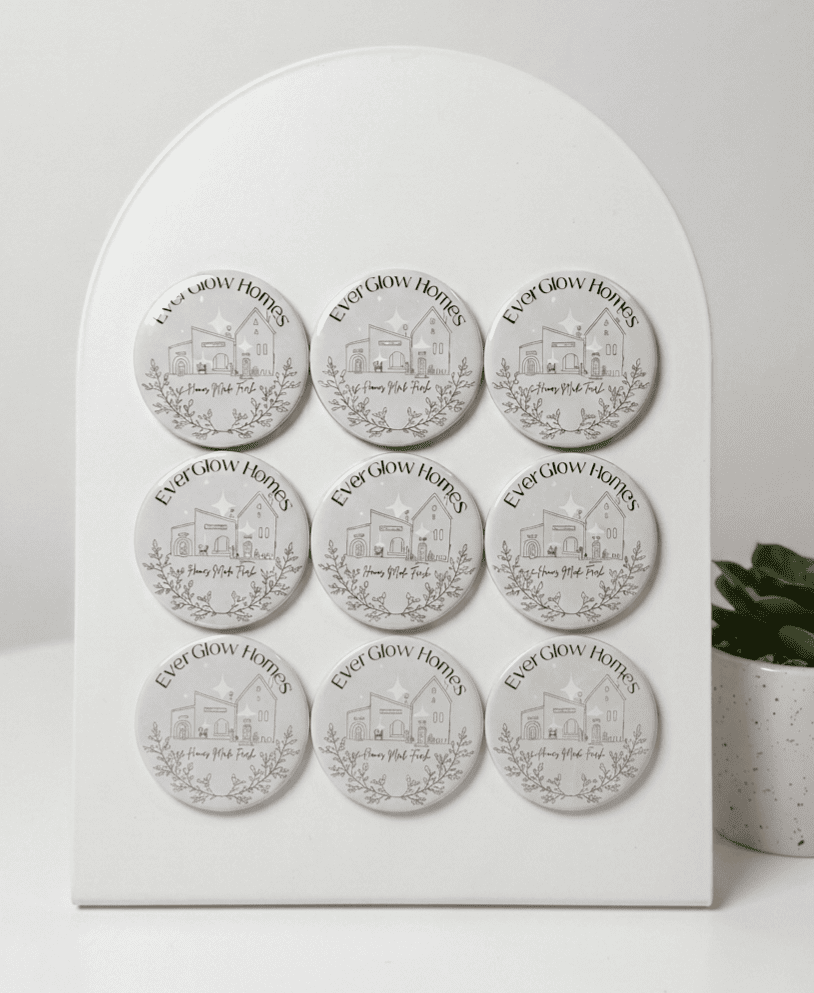 Set of six round coasters with a brand logo on a white display stand.