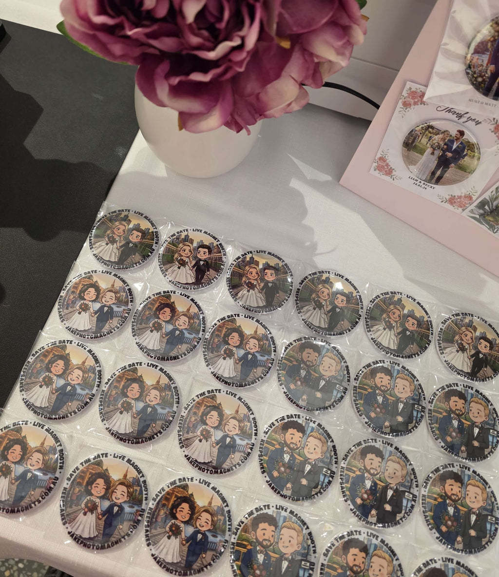 Collection of circular stickers with illustrated characters on a white surface, with a vase of pink flowers in the background.