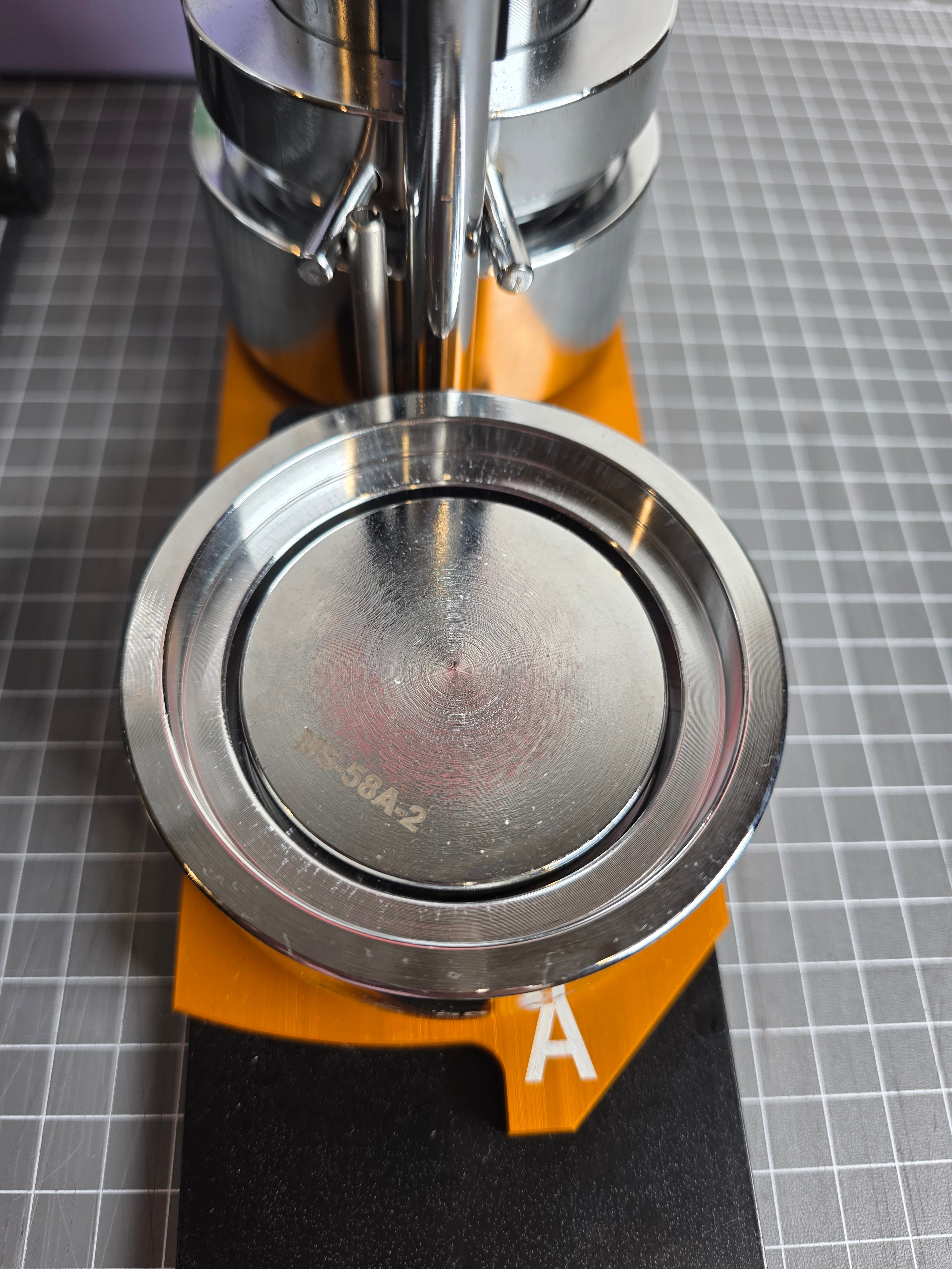 close up of side a of badge maker