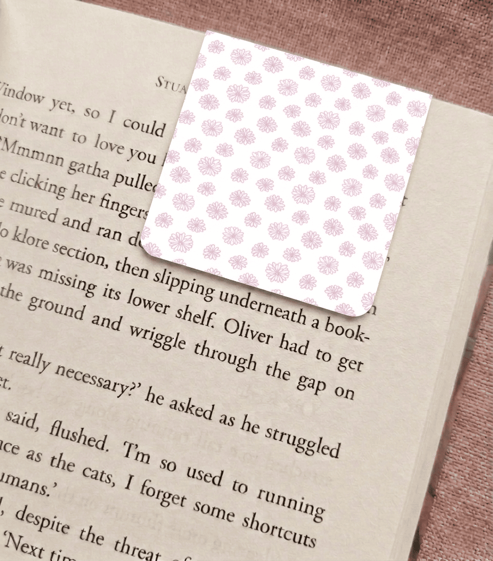 Floral bookmark on a book page with a pink floral pattern