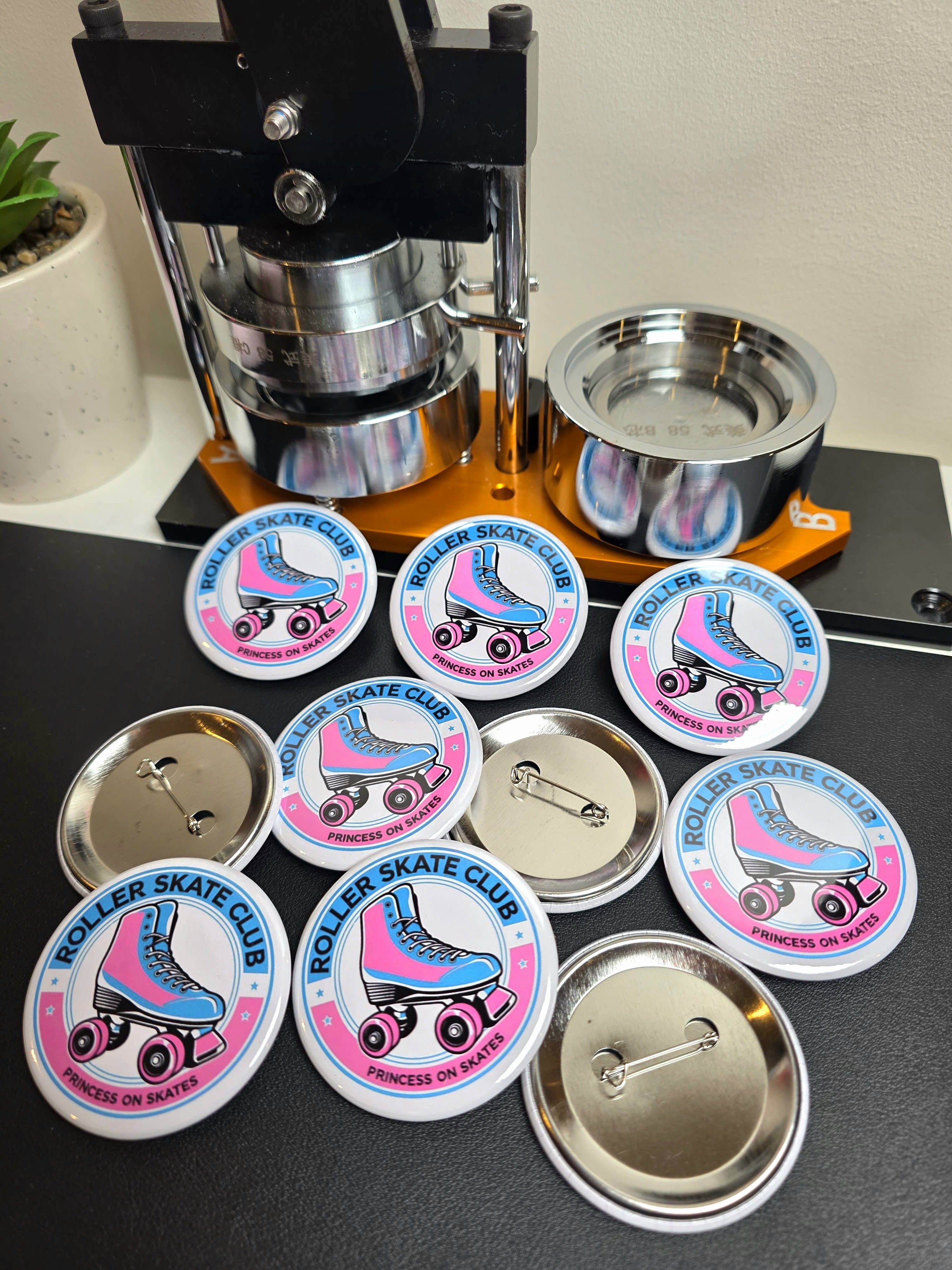 Roller skate club buttons with a button-making machine in the background