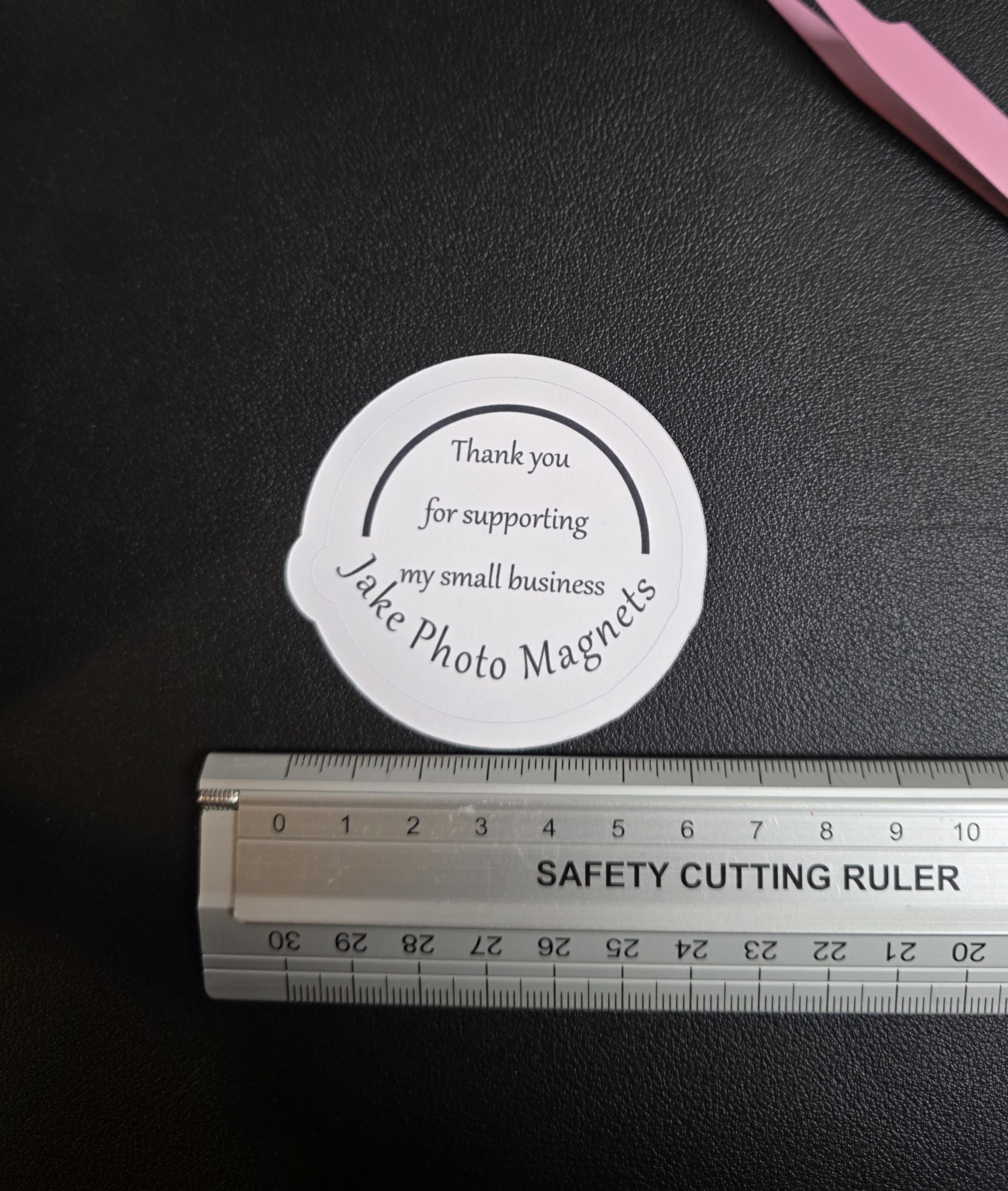 circle custom thank you packaging stickers with a ruler for scale