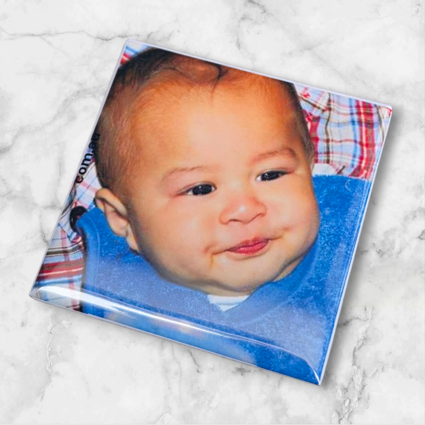 Custom 2x2 inch bubble photo magnets with baby wearing a blue bib.