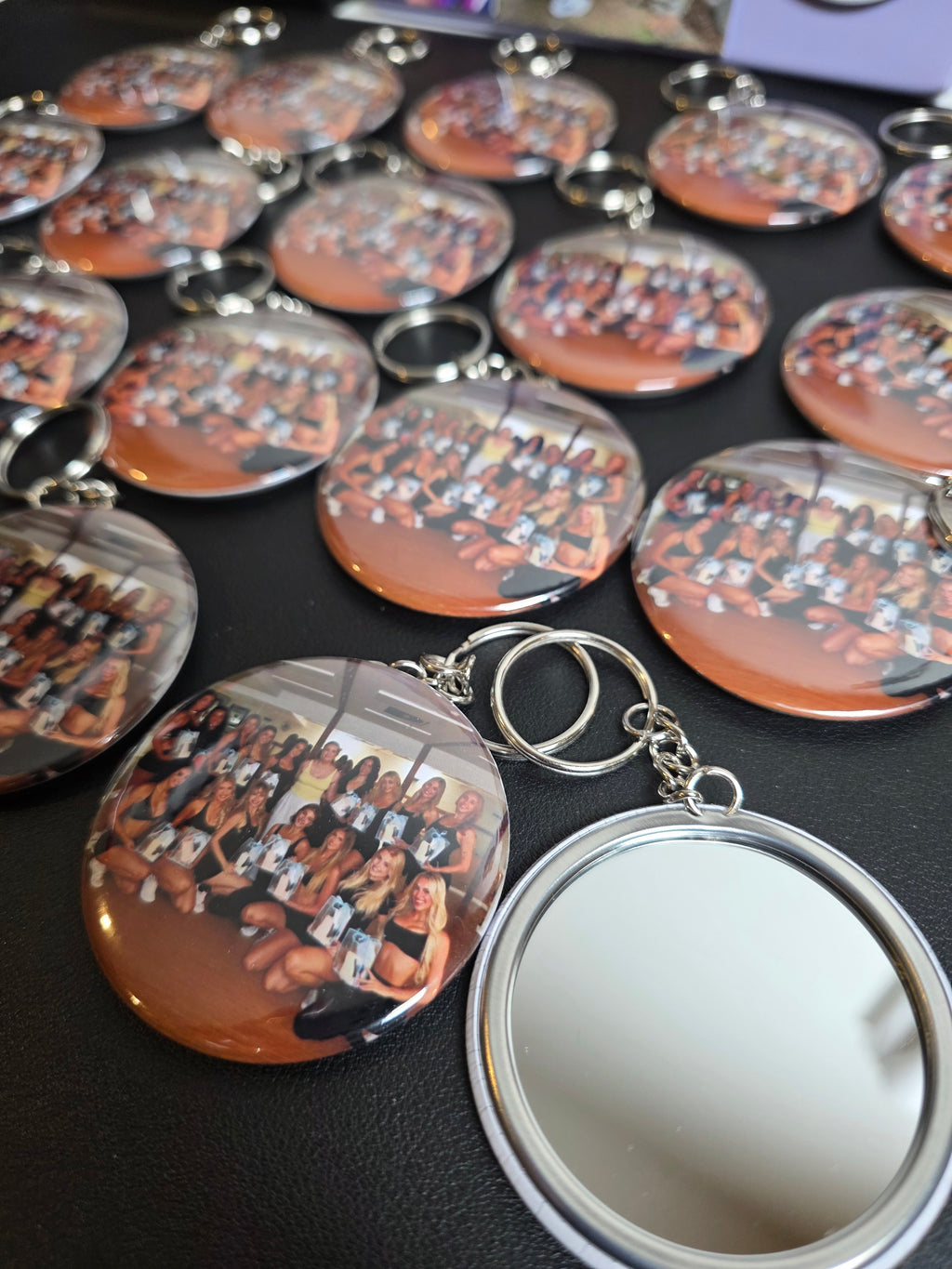 Collection of keychains with reflective surfaces on a dark surface
