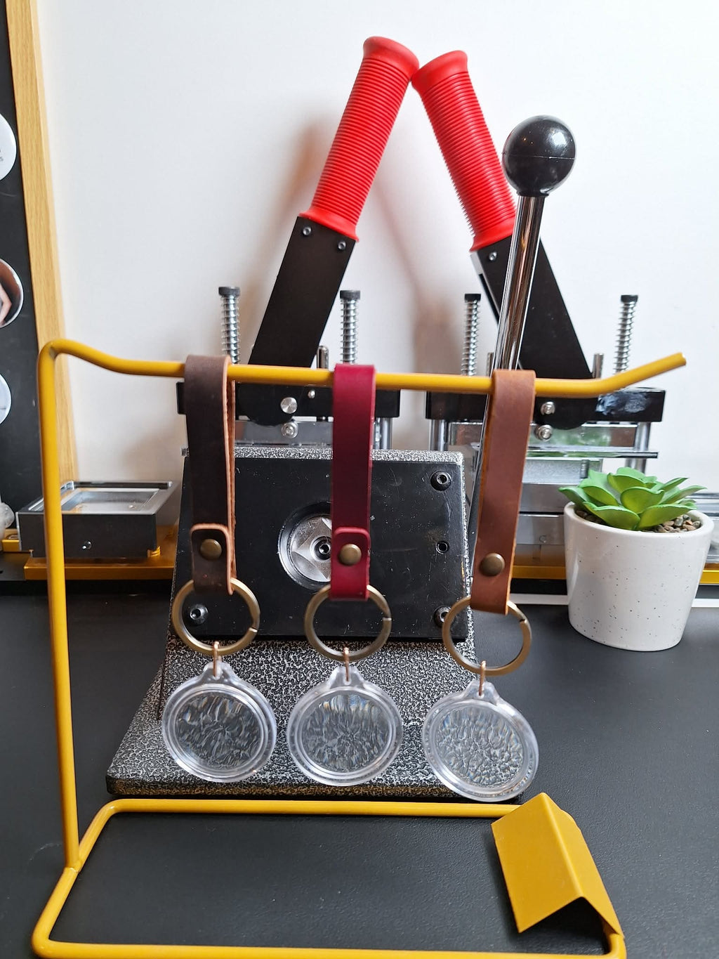 Keychain holder with keys on a stand against a neutral background